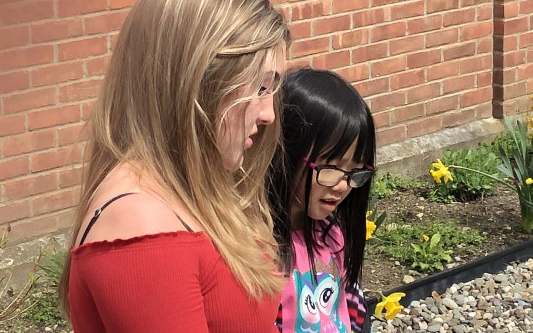 student reading to child