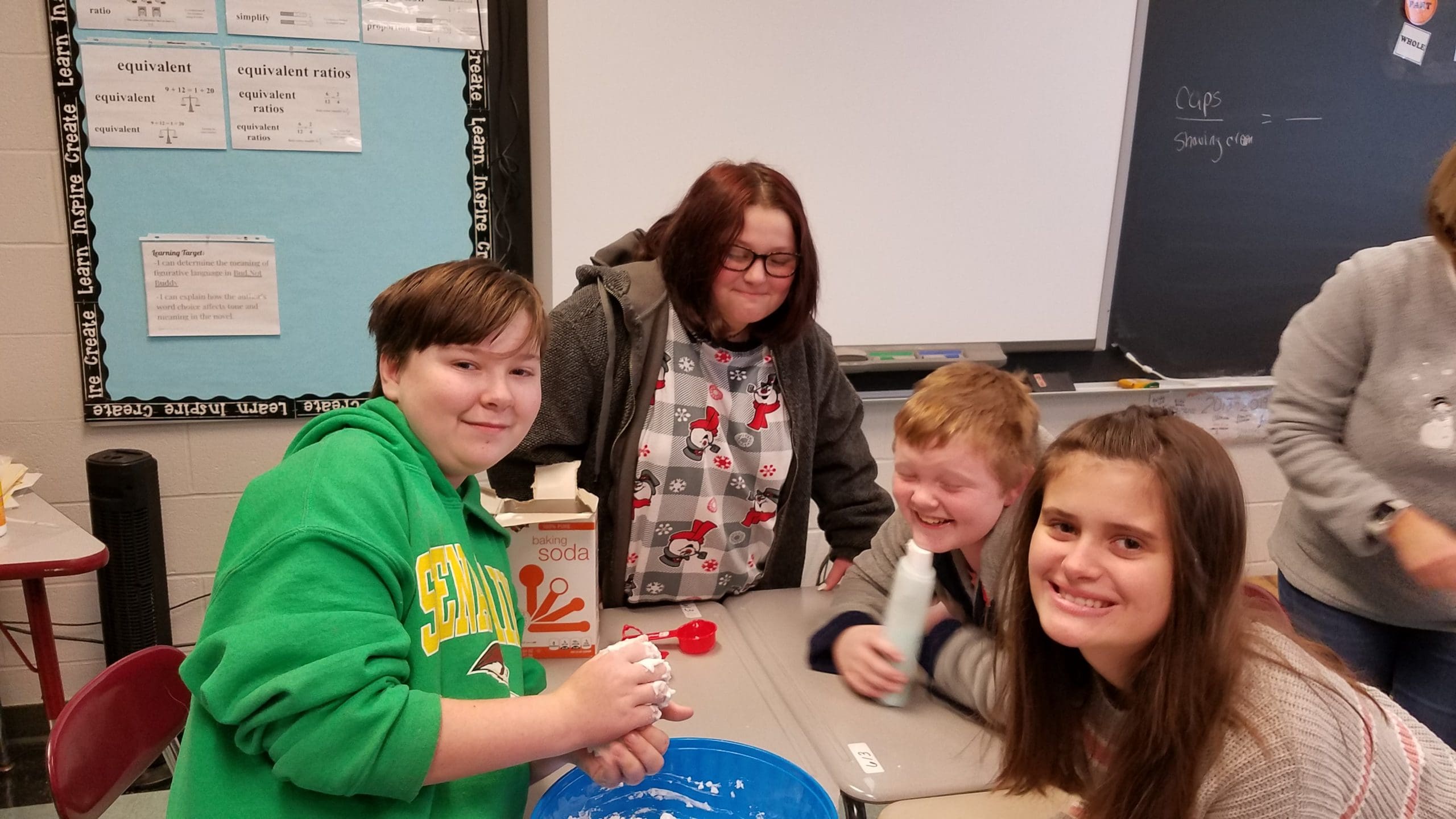 students and teacher make snow