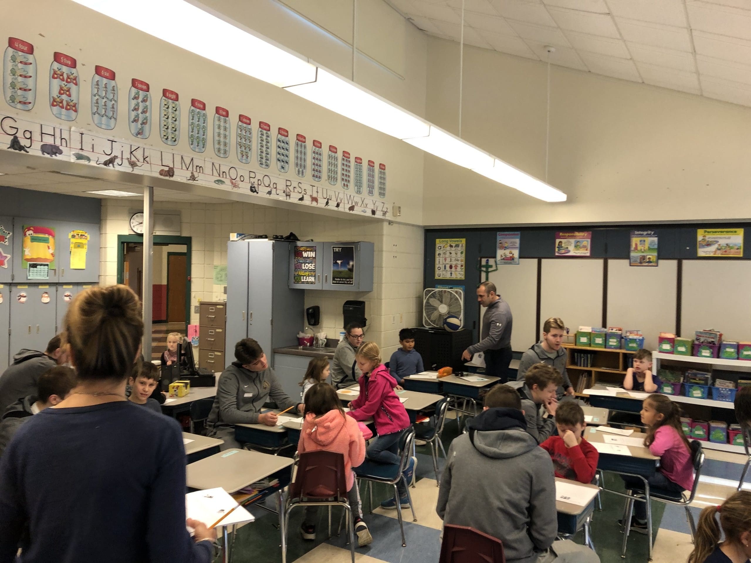 athletes speaking with students