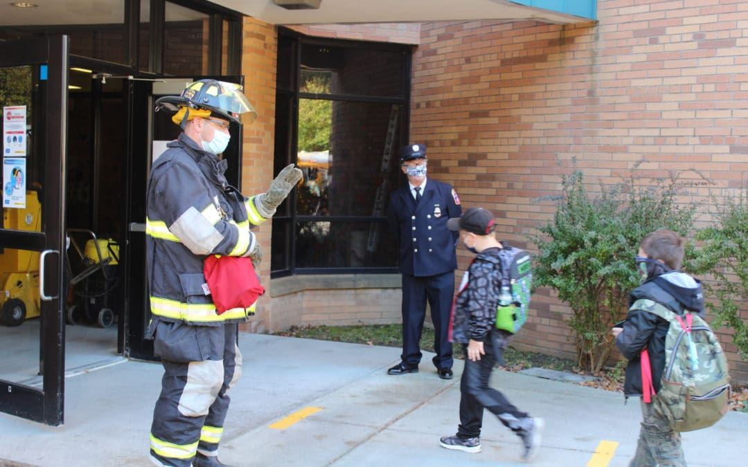 firefighters greet students