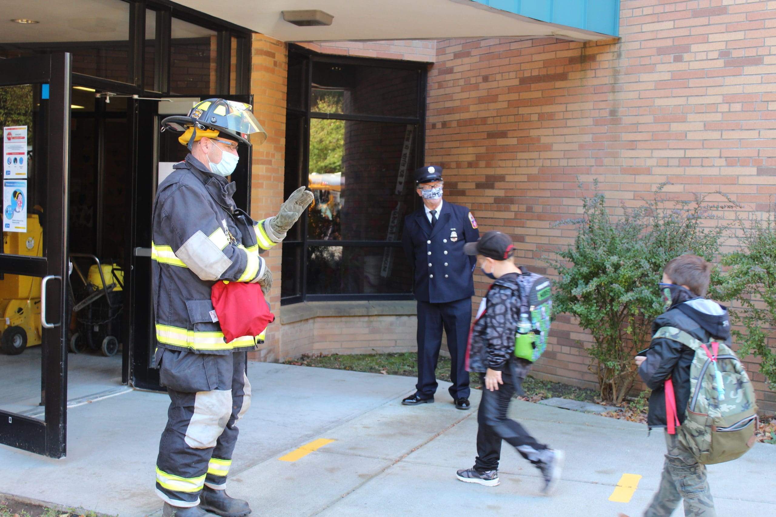 firefighters greet students