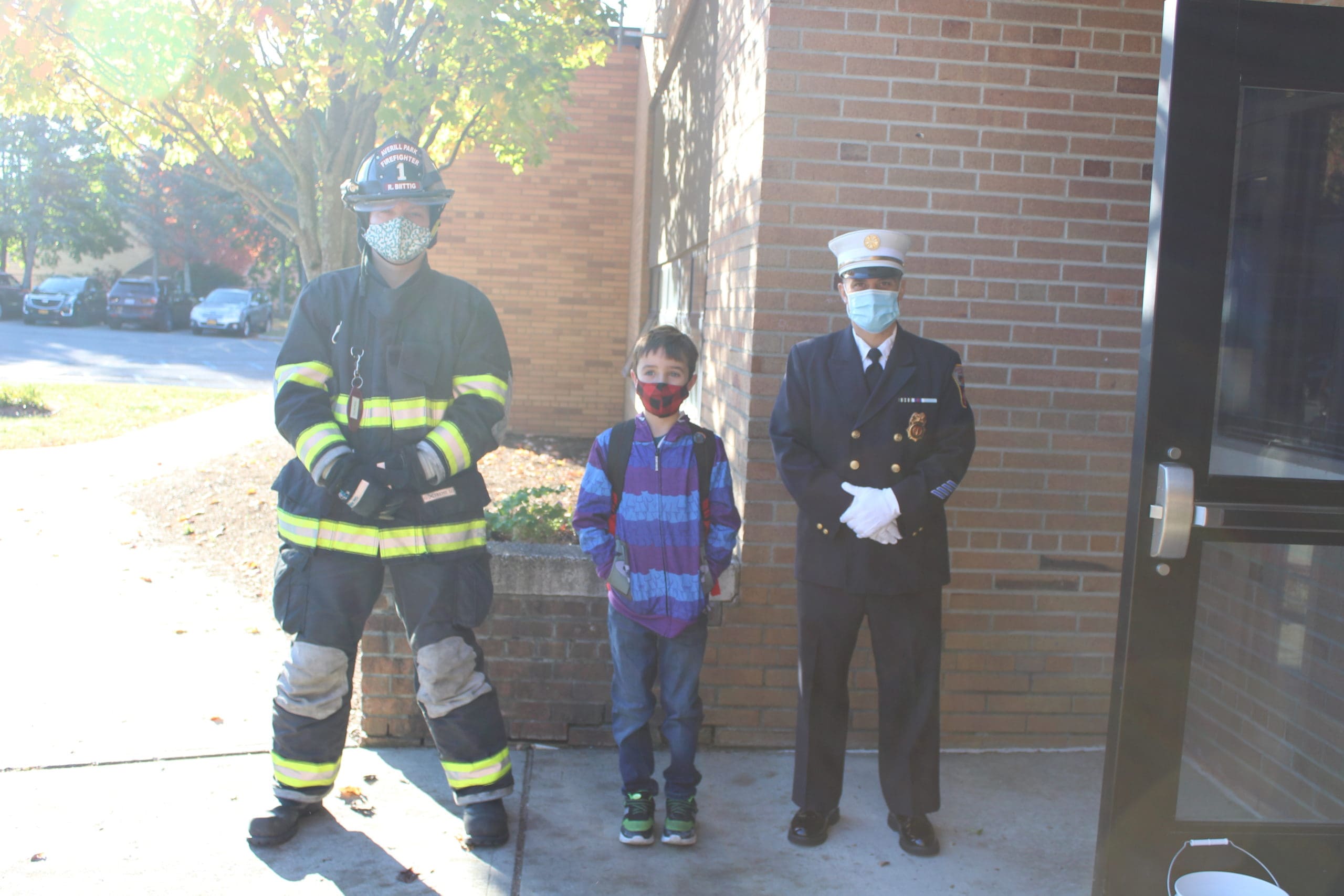 firefighters with student