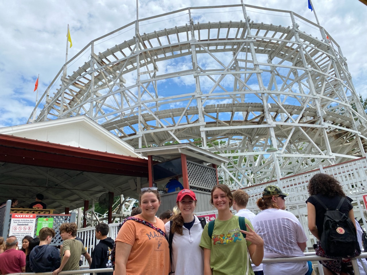 students in front of a rollercoaster