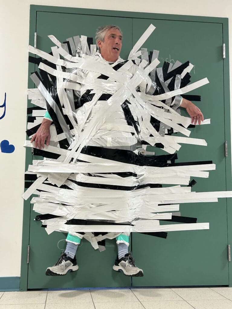 mr sibson taped to the wall
